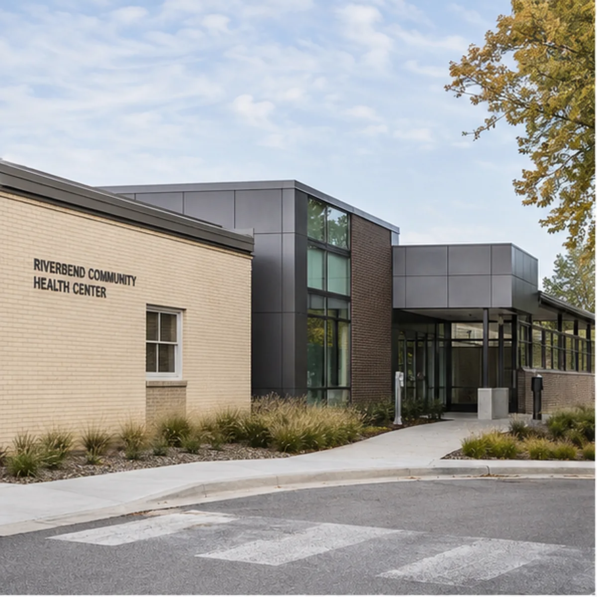Riverbend clinic exterior showing a modest contemporary expansion joined to the existing masonry building.