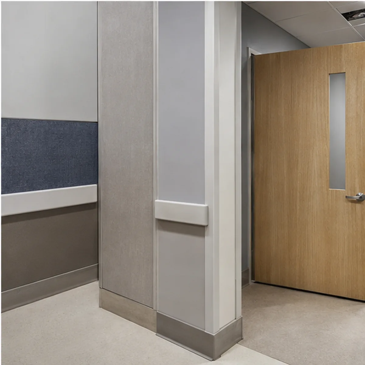 Riverbend durable healthcare-renovation detail at wall base, door, and service-zone transitions.