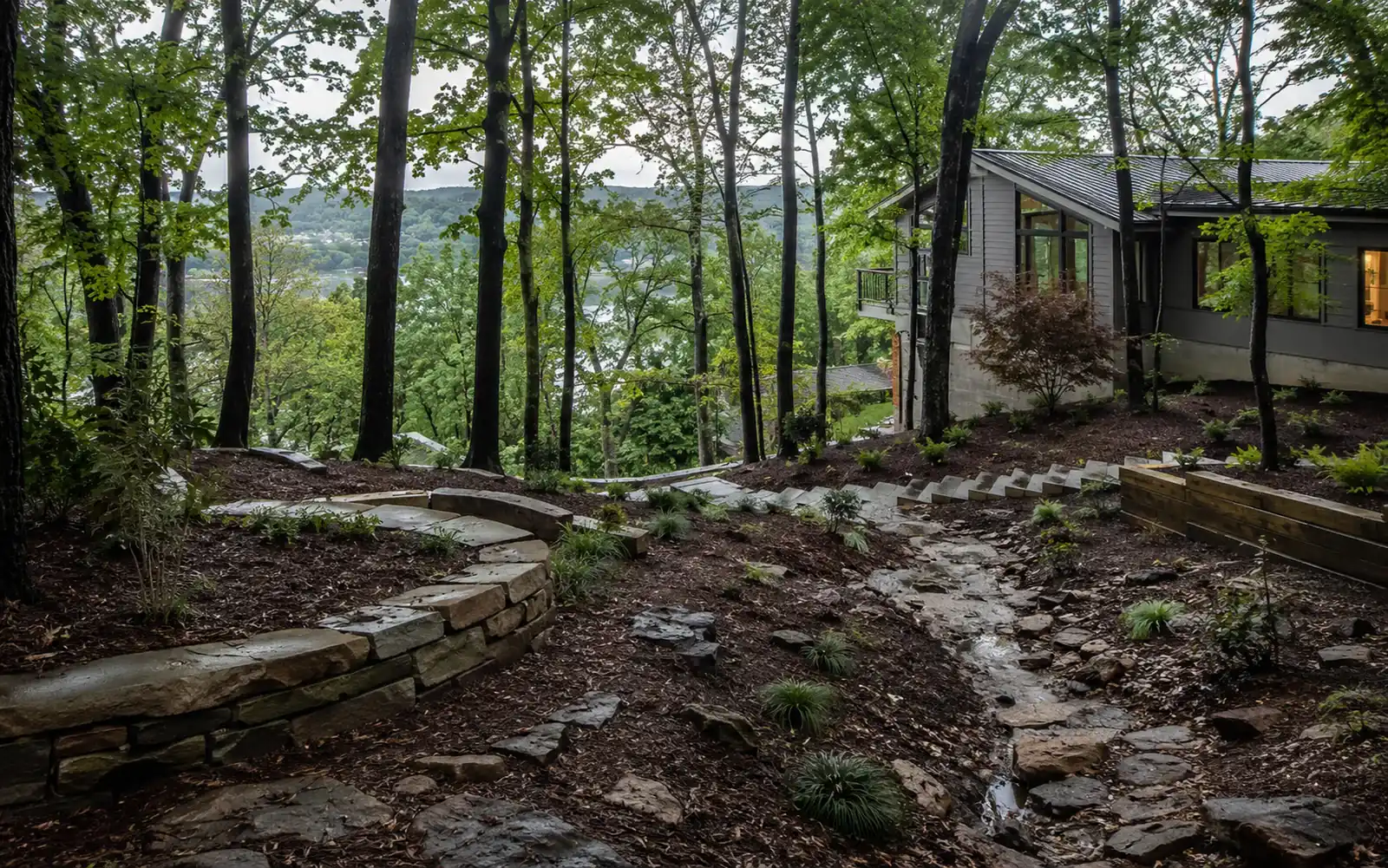 Sloped wooded Chattanooga-area property showing grade, stone paths, planting, and drainage conditions.