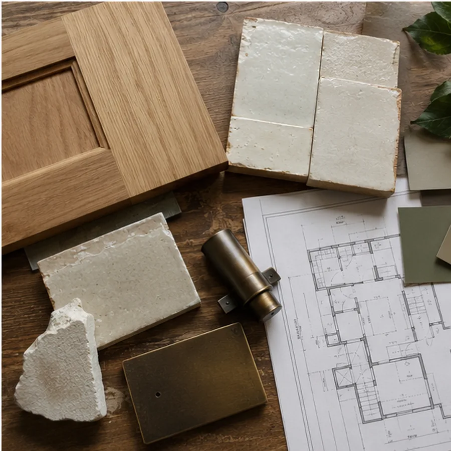 Renovation material study with wood, handmade tile, plaster, metal, and plans.
